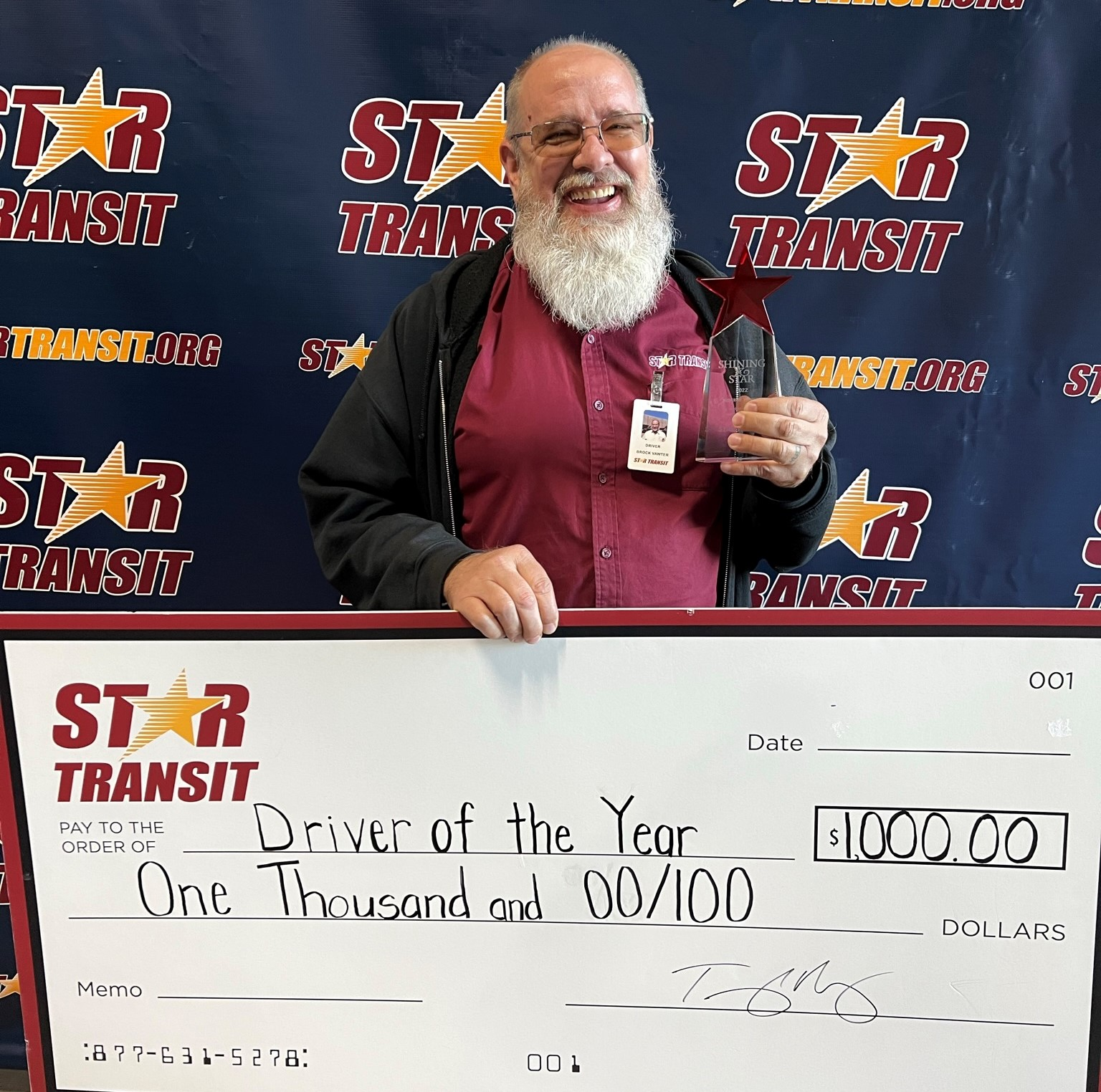 Brock Vawter receiving his $1,000 check for the Star Transit 2022 Driver of the Year.