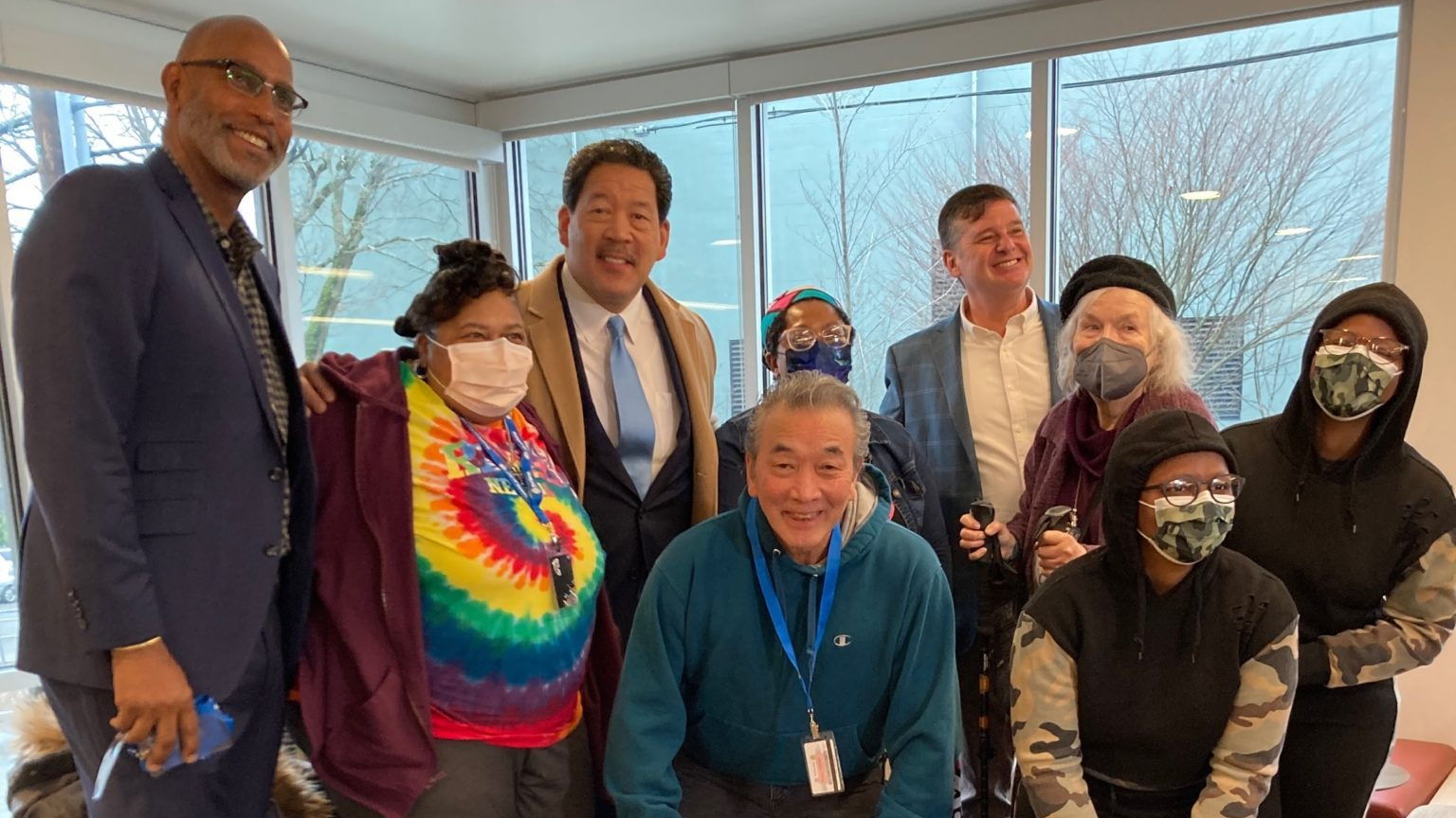 SHA Executive Director Rod Brandon, far left, Seattle Mayor Bruce Harrell, center in light blue tie, and SDOT Director Greg Spotts, in blue jacket, along with Seattle Housing Authority residents celebrated the SHA Transit Pass program on Jan. 24.