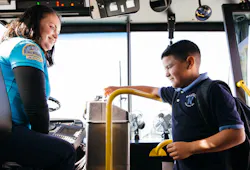 A young boy paying for fare while boarding a Santa Cruz Metro bus. A young boy paying for fare while boarding a Santa Cruz Metro bus.