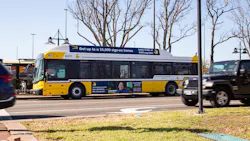 A Dallas Area Rapid Transit bus is seen driving in Downtown Dallas, Texas, with a local advertisement depicted on the side of the bus. A Dallas Area Rapid Transit bus is seen driving in Downtown Dallas, Texas, with a local advertisement depicted on the side of the bus.