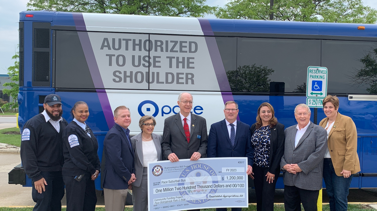 (L to R) Dispatcher/Supervisor Maurice Shelton, Bus Operator Barbette Easley, Pace Director John Noak, Pace Executive Director Melinda J. Metzger, Congressman Bill Foster, Pace Chairman Rick Kwasneski, Bolingbrook Mayor Mary Alexander-Basta, Pace Director Jeff Schielke and Will County Executive Jennifer Bertino-Tarrant receive funding in front of an I-55 Express Bus that will serve the improved facility.