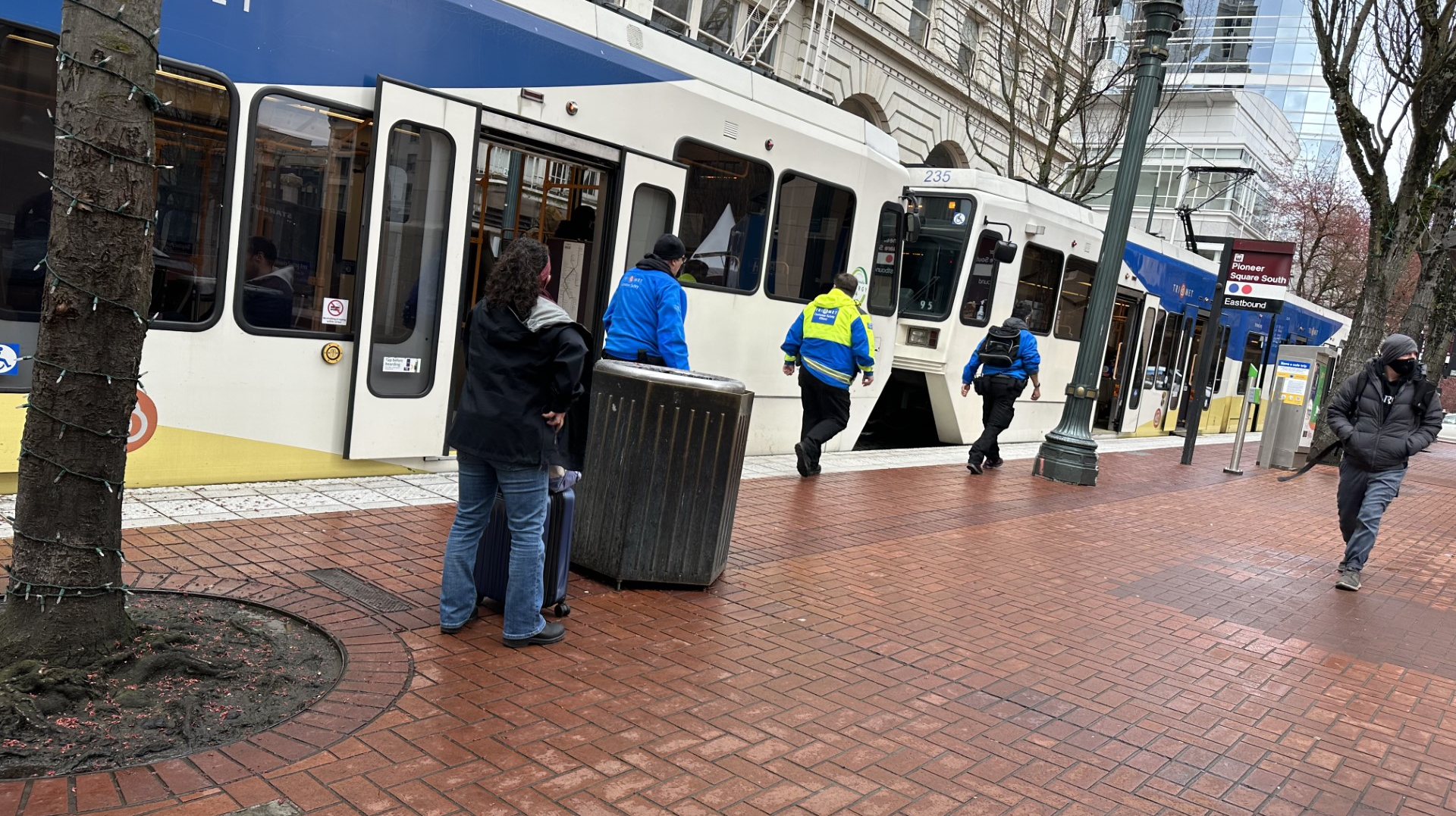 Members of TriMet's Community Safety Team checking a train in downtown Portland, Ore., in April 2023.