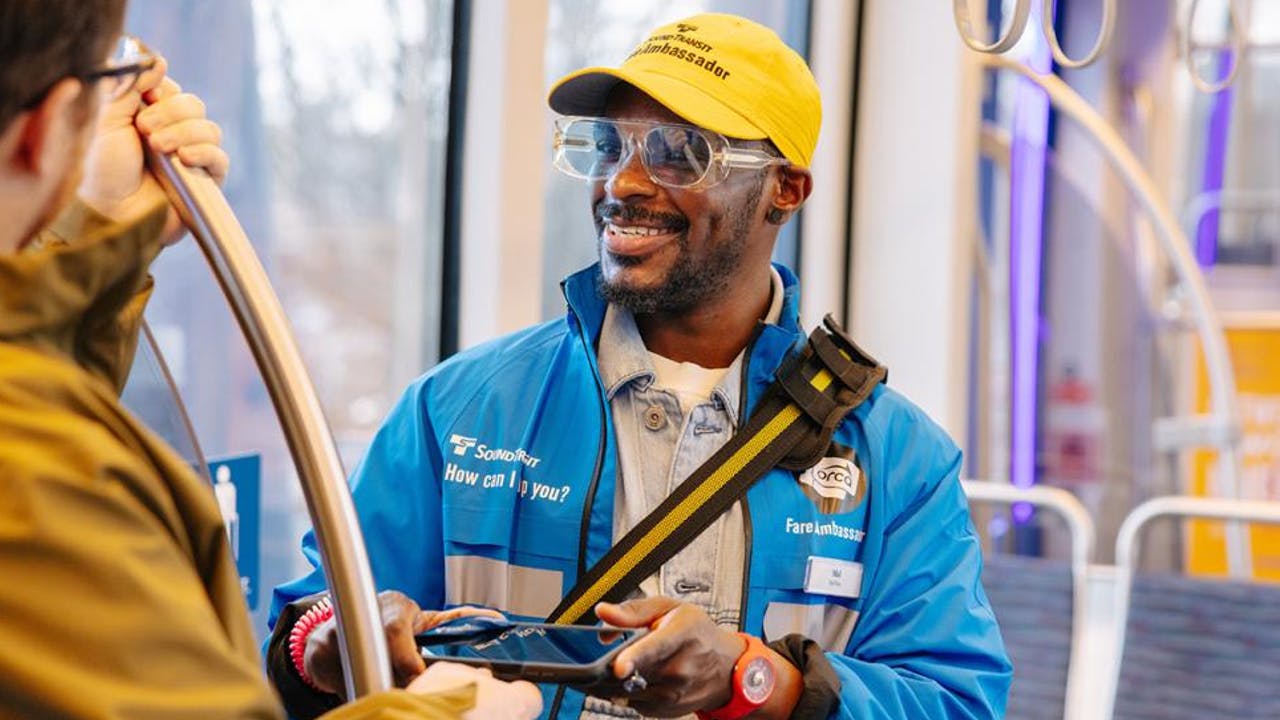 Sound Transit fare ambassador on train.