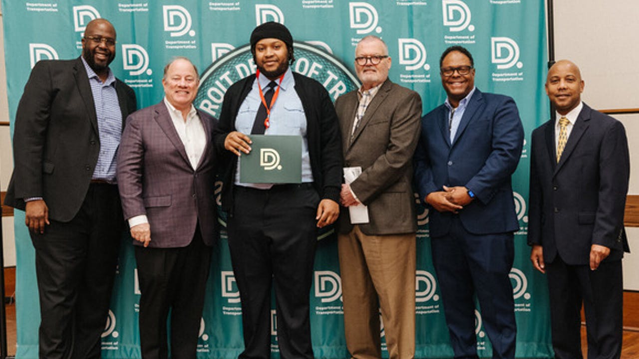 New DDOT Transit Equipment Operator Richard Smith joins Mayor Duggan, Deputy Mayor Bettison and DDOT officials to celebrate his graduation..