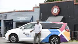 A Metro Flex driver smiles while parked next to South Park Suds Laundromat. A Metro Flex driver smiles while parked next to South Park Suds Laundromat.