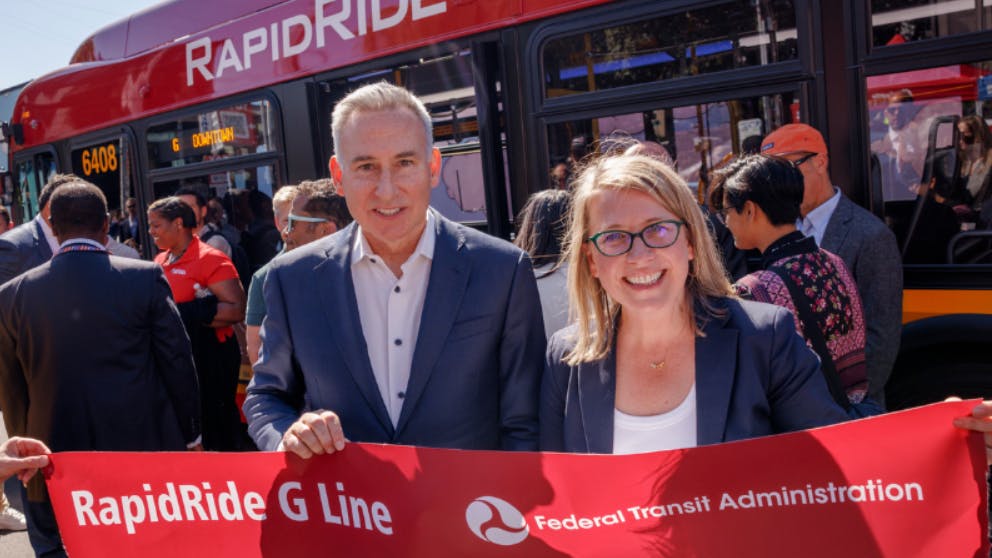 King County Executive Dow Constantine and King County Metro General Manager Michelle Allison with a piece of the ribbon at the RapidRide G Line ribbon cutting celebration.