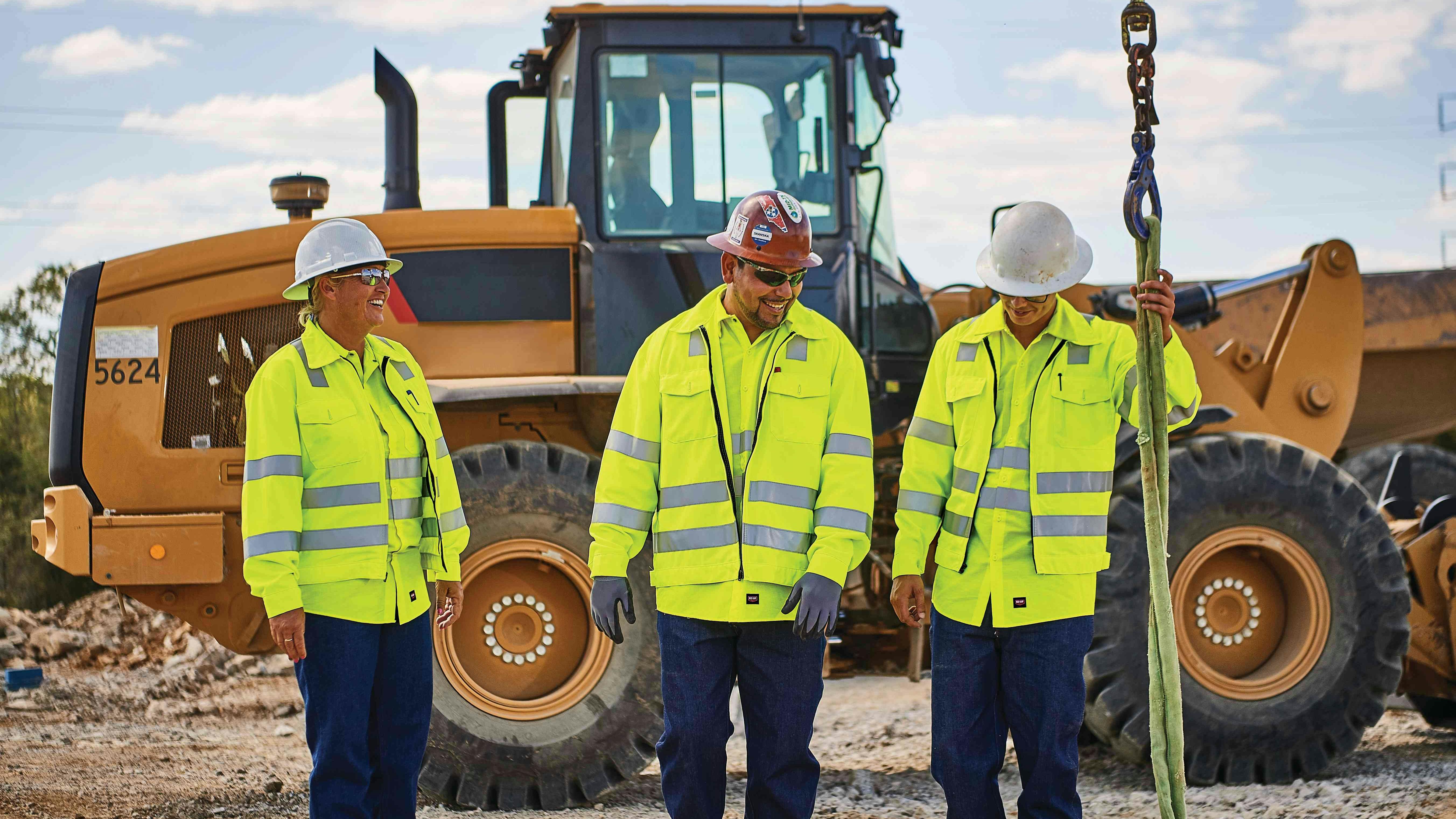 Construction workers wearing high-visibility uniforms.