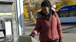 A rider tapping her card on a Metro Transit bus in Minneapolis. A rider tapping her card on a Metro Transit bus in Minneapolis.