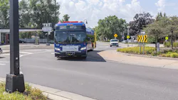 METRO D Line bus drives down the street during the day METRO D Line bus drives down the street during the day