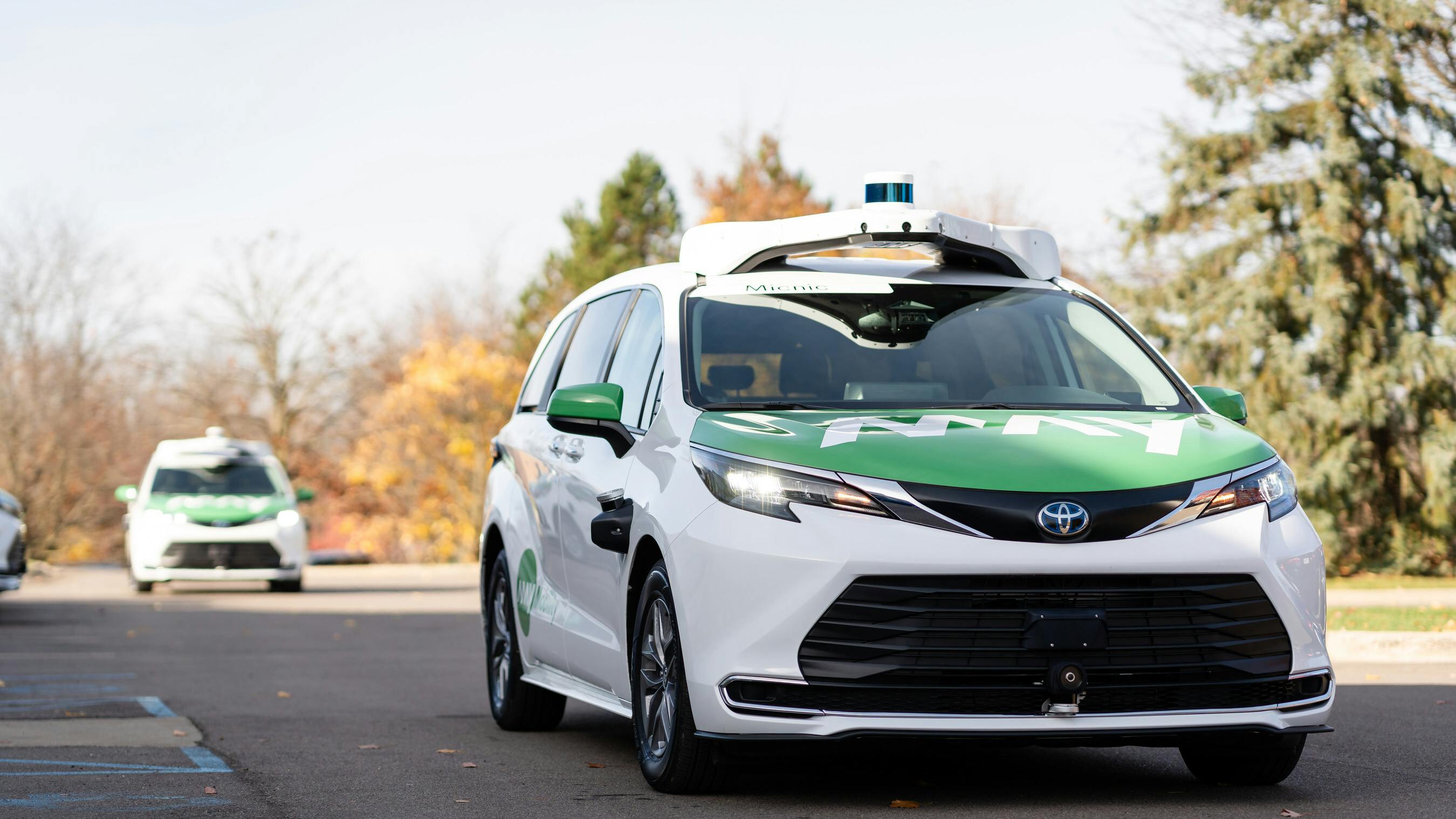 a may mobility sedan drives down road in Ann Arbor with no driver