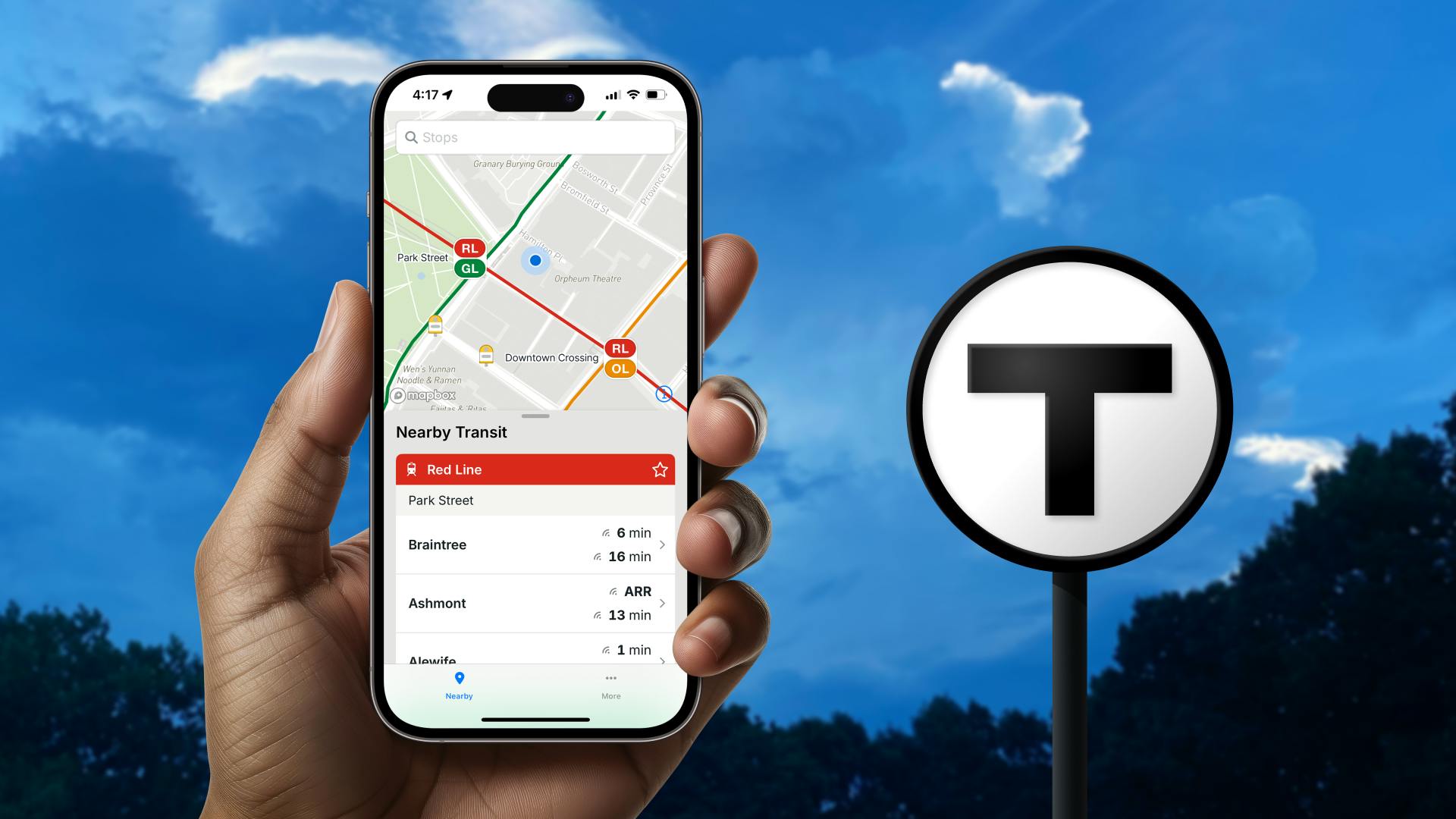 a hand hols an iphone showing vehicle tracking on the screen with the T logo in the background