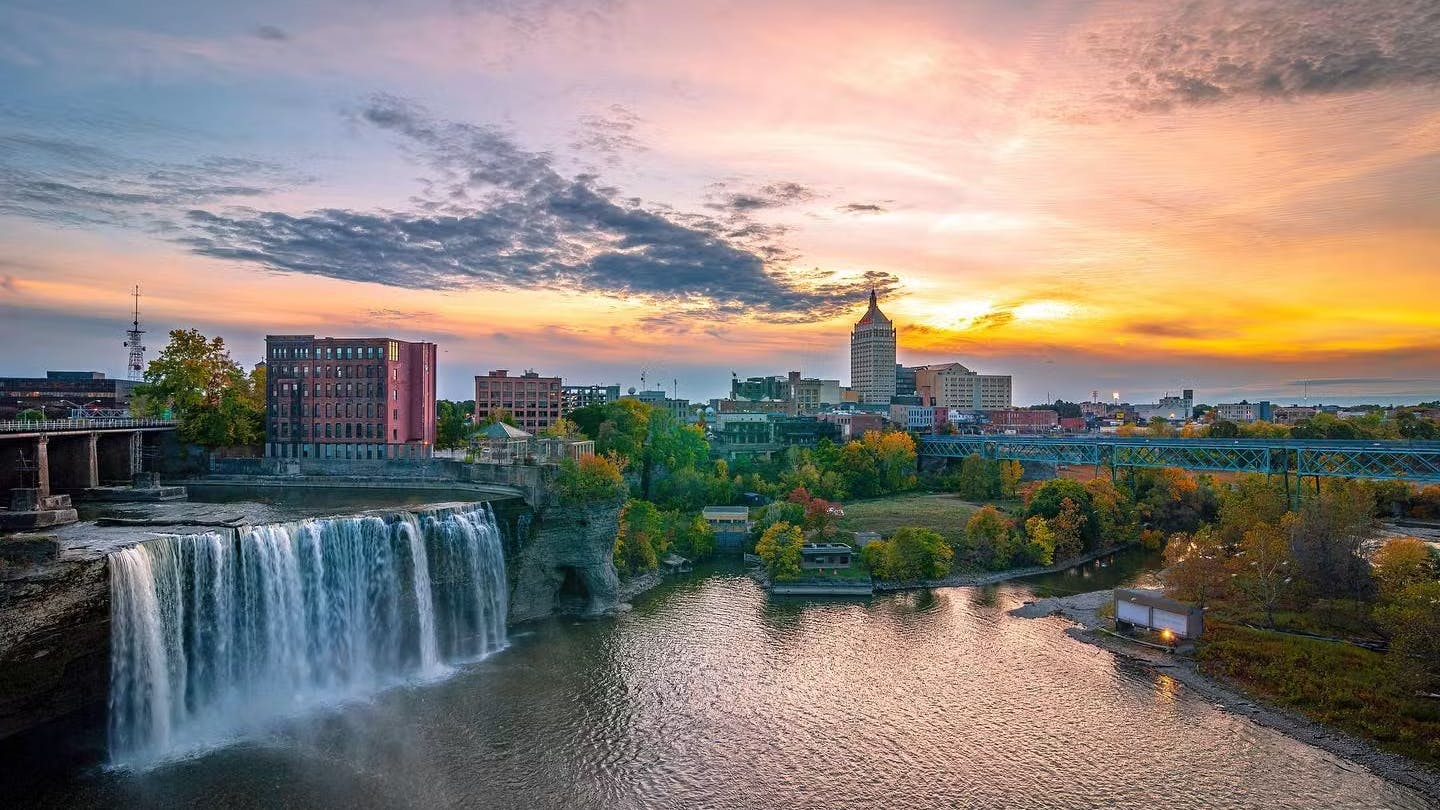 picture of Rochester NY's skyline at sunset with water fall