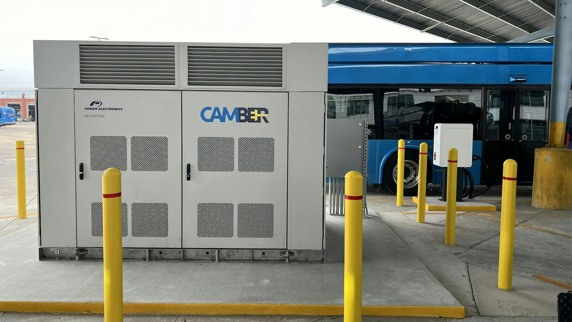 camber charger sits in front of CapMetro electric bus