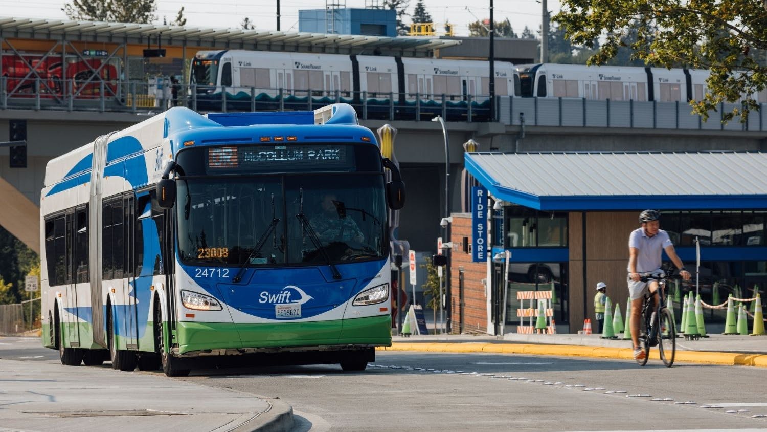 A Swift Orange Line bus drives through Lynnwood City Center Station.