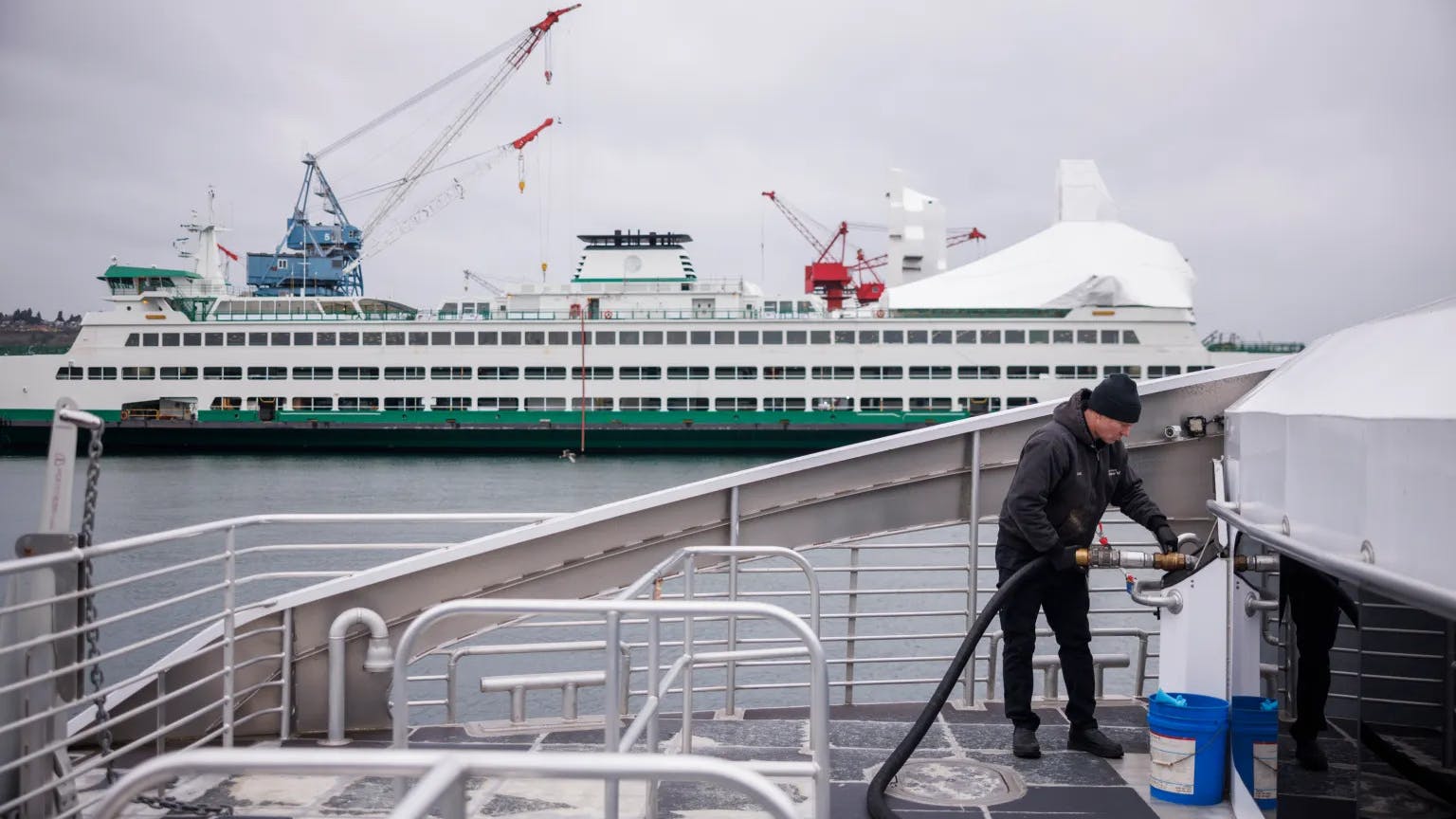 Water taxi crew member fuels the Doc Maynard.