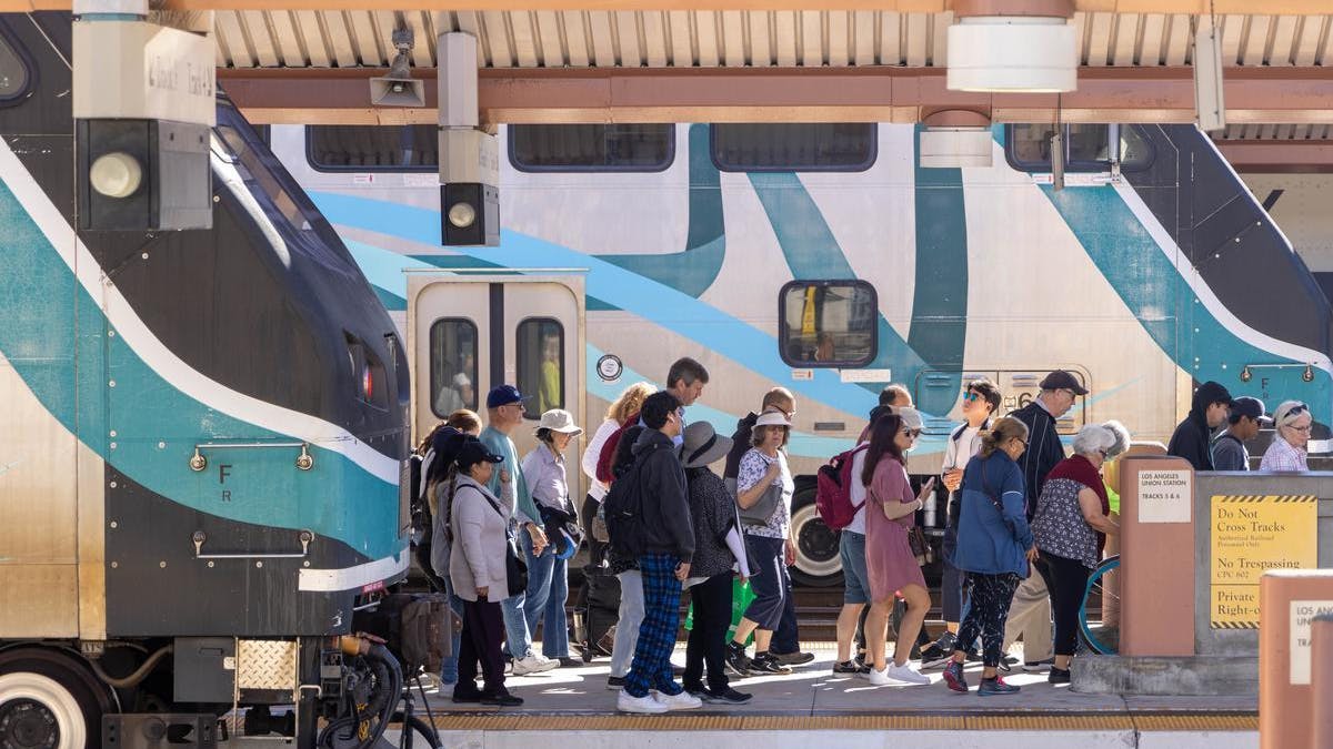 people exit a Metrolink train onto a station platform