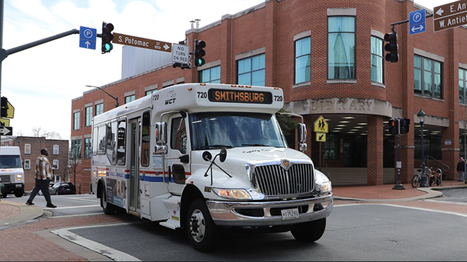WCT cutaway bus travels down a street
