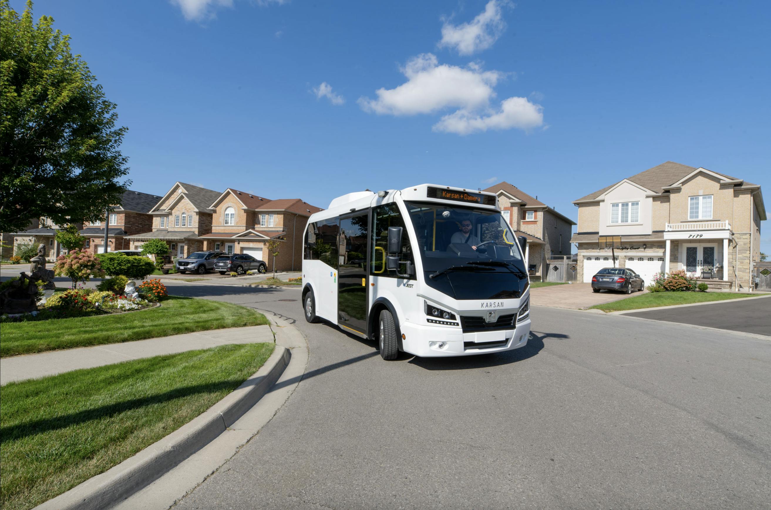 Karsan eJEST minibus drives through a neighborhood street