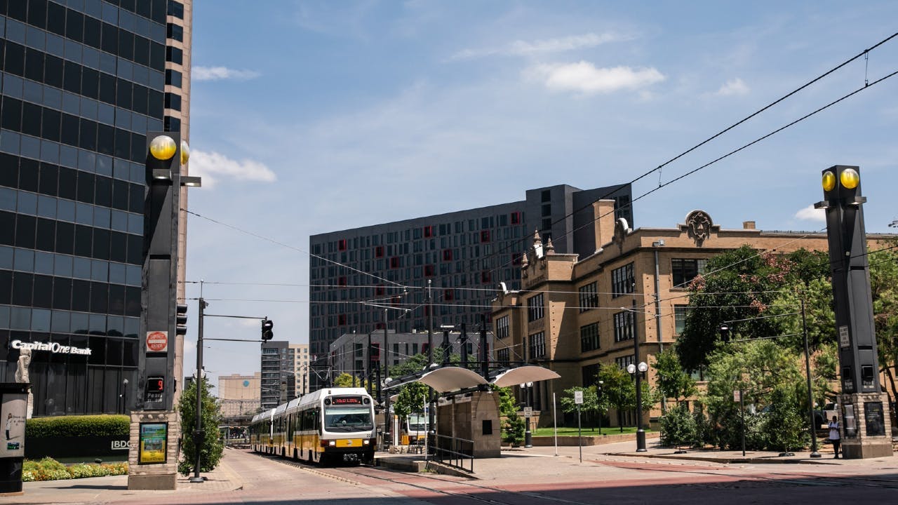 dart train pulls up to a station in North Dallas in downtown