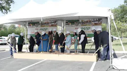 stakeholders stand in a line in front of a VIA Green Line banner and dig shovels into a box of dirt stakeholders stand in a line in front of a VIA Green Line banner and dig shovels into a box of dirt