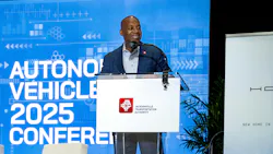 JTA CEO Nat Ford stands at a podium with the JTA logo on the front and a screen behind him that says autonomous vehicle 2025 conference JTA CEO Nat Ford stands at a podium with the JTA logo on the front and a screen behind him that says autonomous vehicle 2025 conference