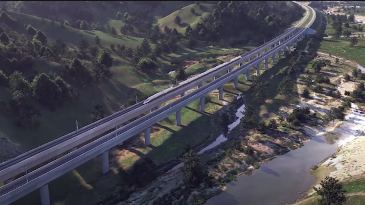 rendering of high speed train running on elevated guideway over fields and river