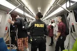 BART police officer on a BART train. BART police officer on a BART train.