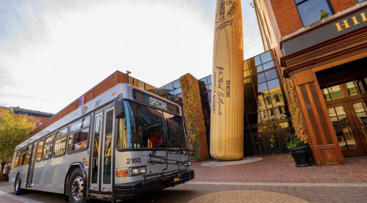 a TARC bus parks in front of the Louisville slugger musuem