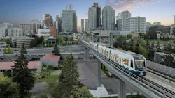 a sound transit train runs on elevated guideway with city skyline in background a sound transit train runs on elevated guideway with city skyline in background