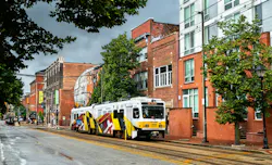 MDOT MTA light rail runs down empty street MDOT MTA light rail runs down empty street
