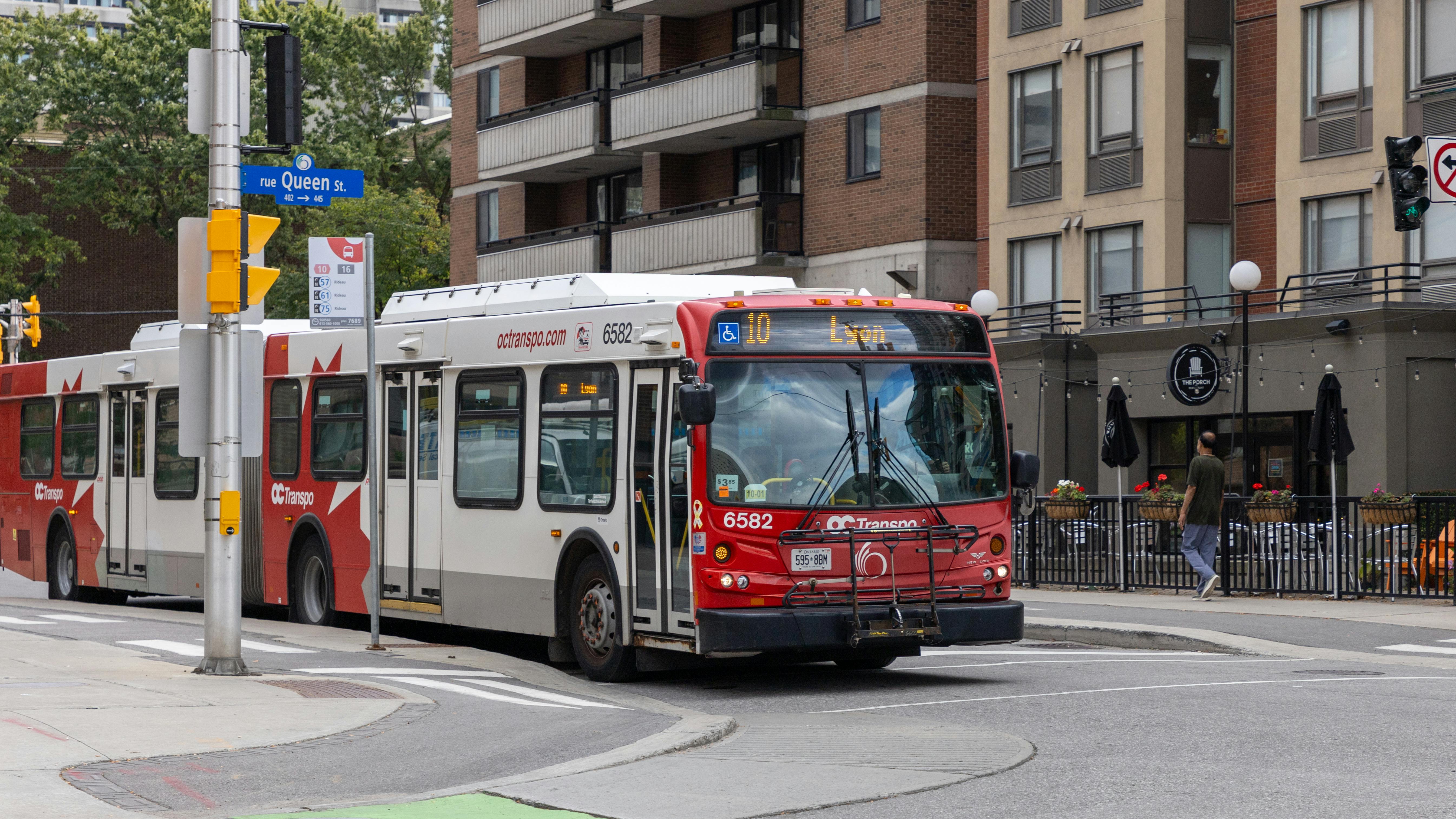 OC Transpo bus drives down a city street in Ottawa