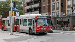 OC Transpo bus drives down a city street in Ottawa OC Transpo bus drives down a city street in Ottawa