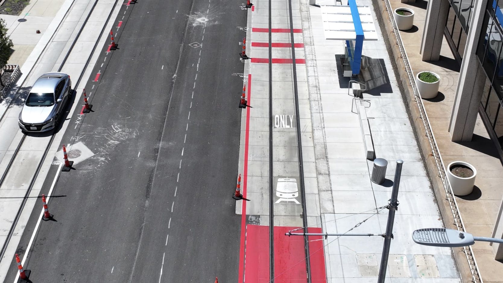 a transit only lane painted in red on the right side of the street in an aerial view