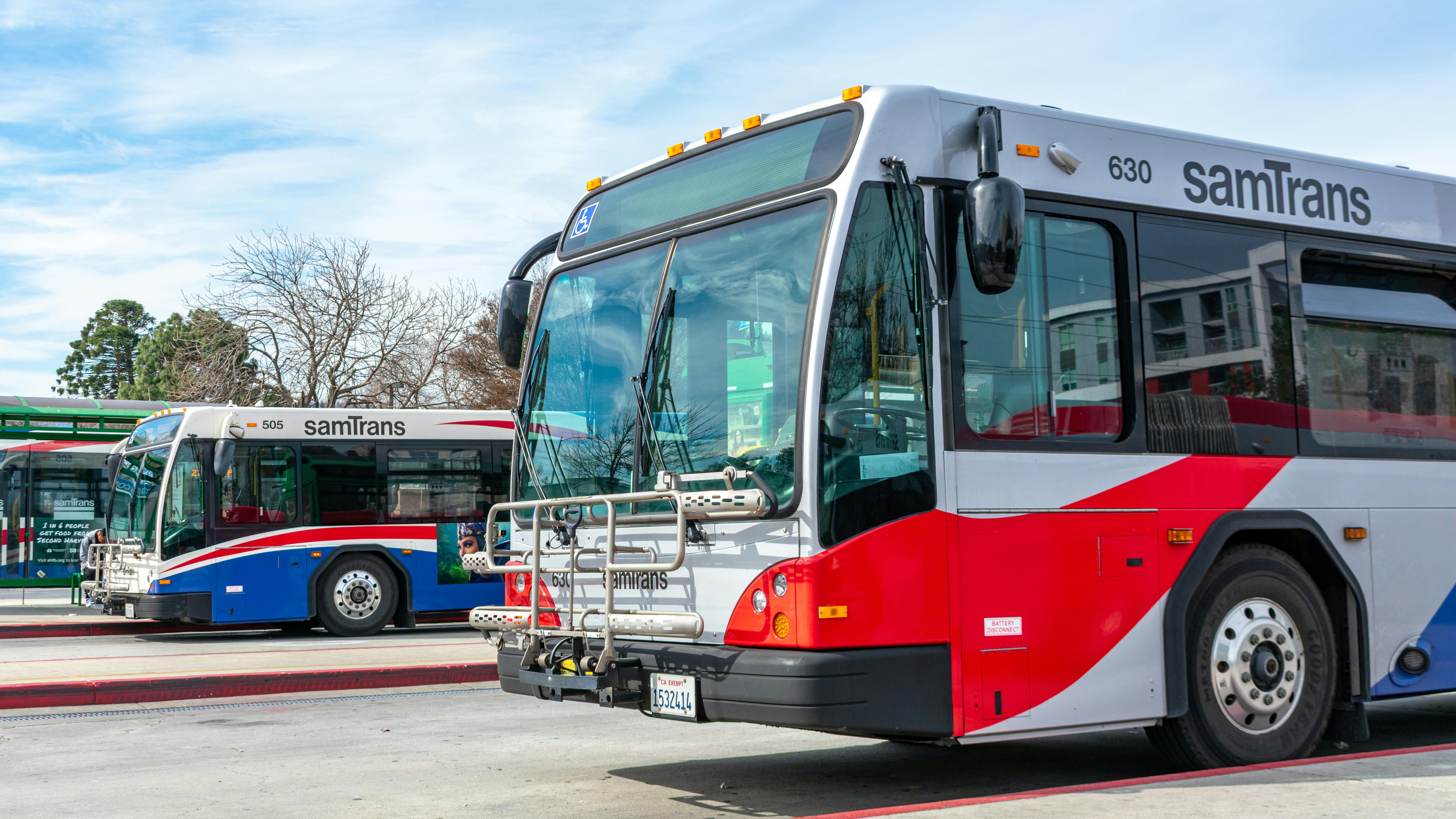 Two SamTrans busses parked at a transit depot in Redwood City, Calif.