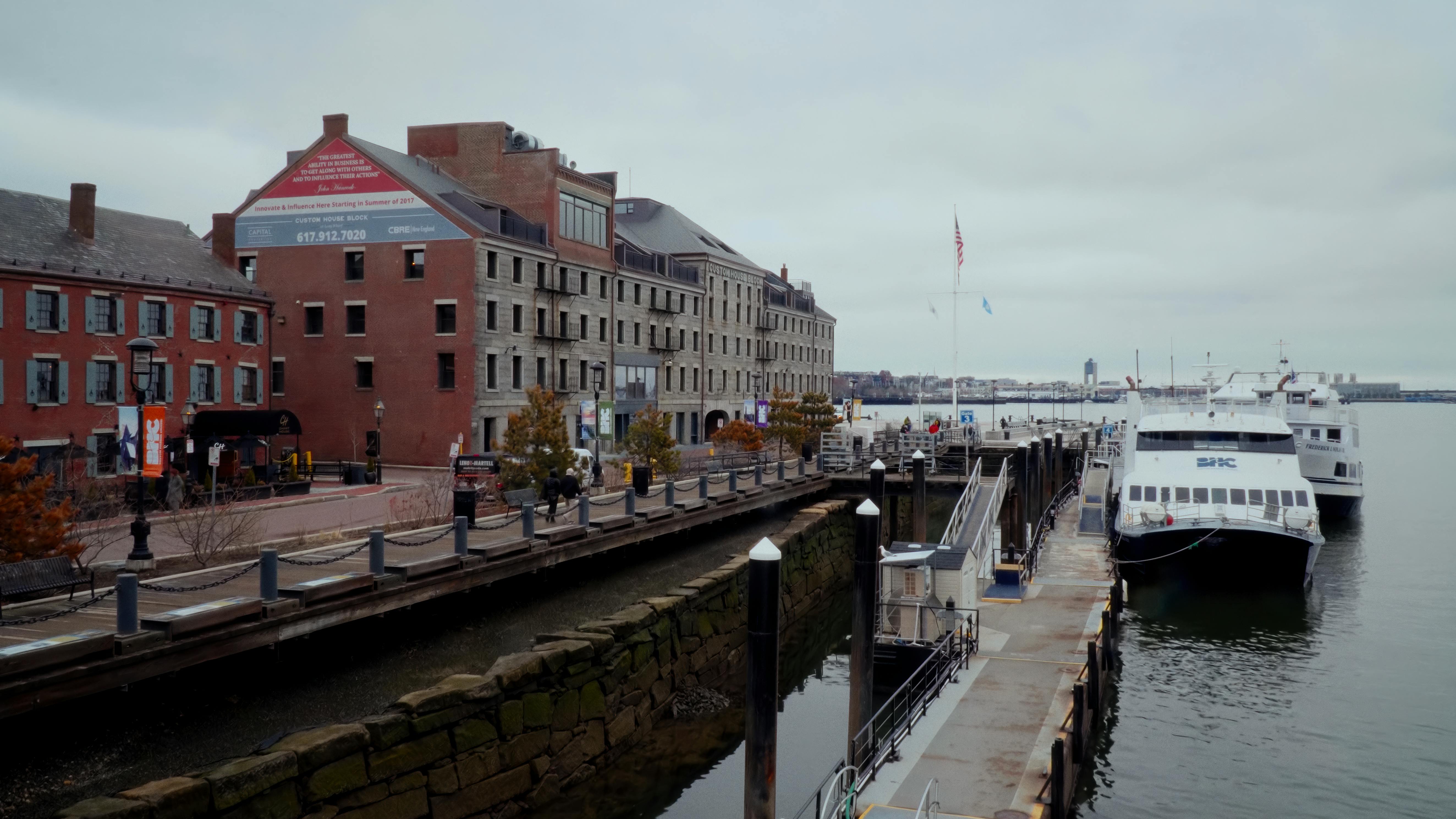 A ferry sits docked at Long Wharf in Boston Harbor.