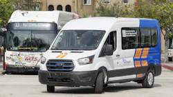 A Southeastern Connect e-transit van sits parked in front of an MTS bus. A Southeastern Connect e-transit van sits parked in front of an MTS bus.