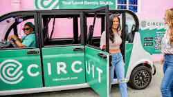 A woman exits a Circuit electric shuttle. A woman exits a Circuit electric shuttle.