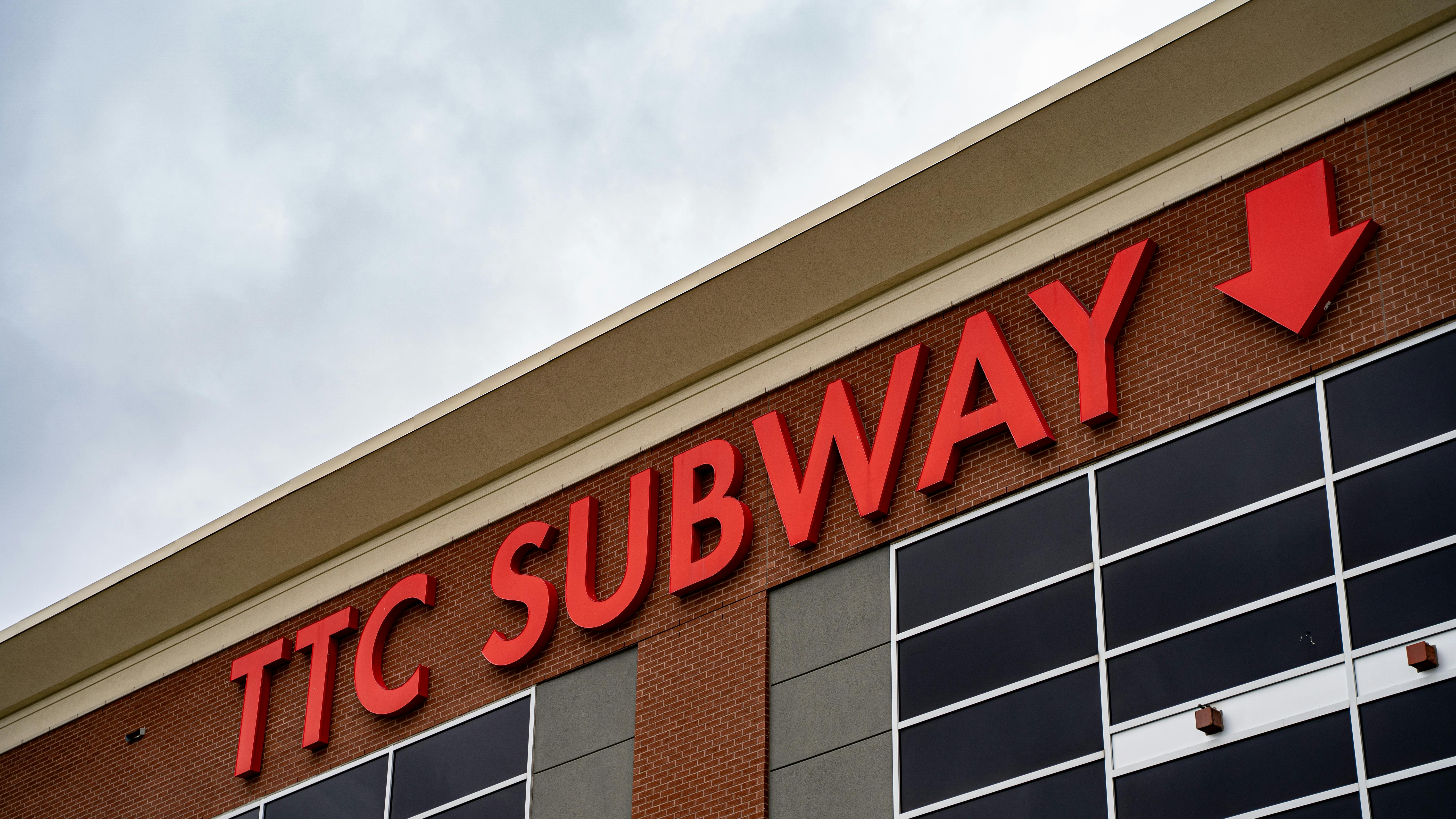 A TTC Subway sign on a brick building.