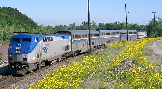 The Heartland Flyer train travels down the track.