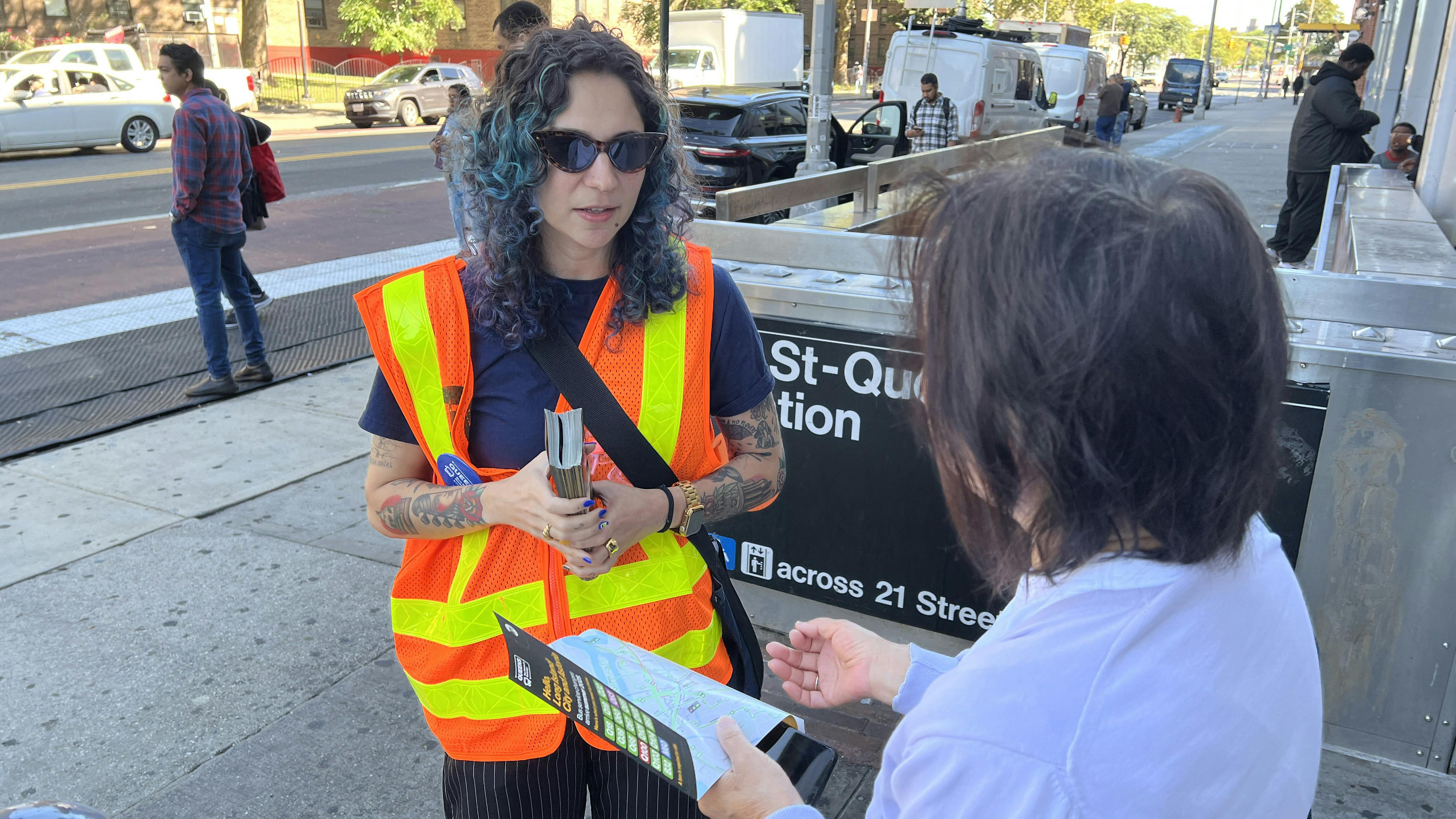 An MTA employee directs a traveler on the new bus routes.
