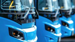 Buses sit in a line next to each other. Buses sit in a line next to each other.