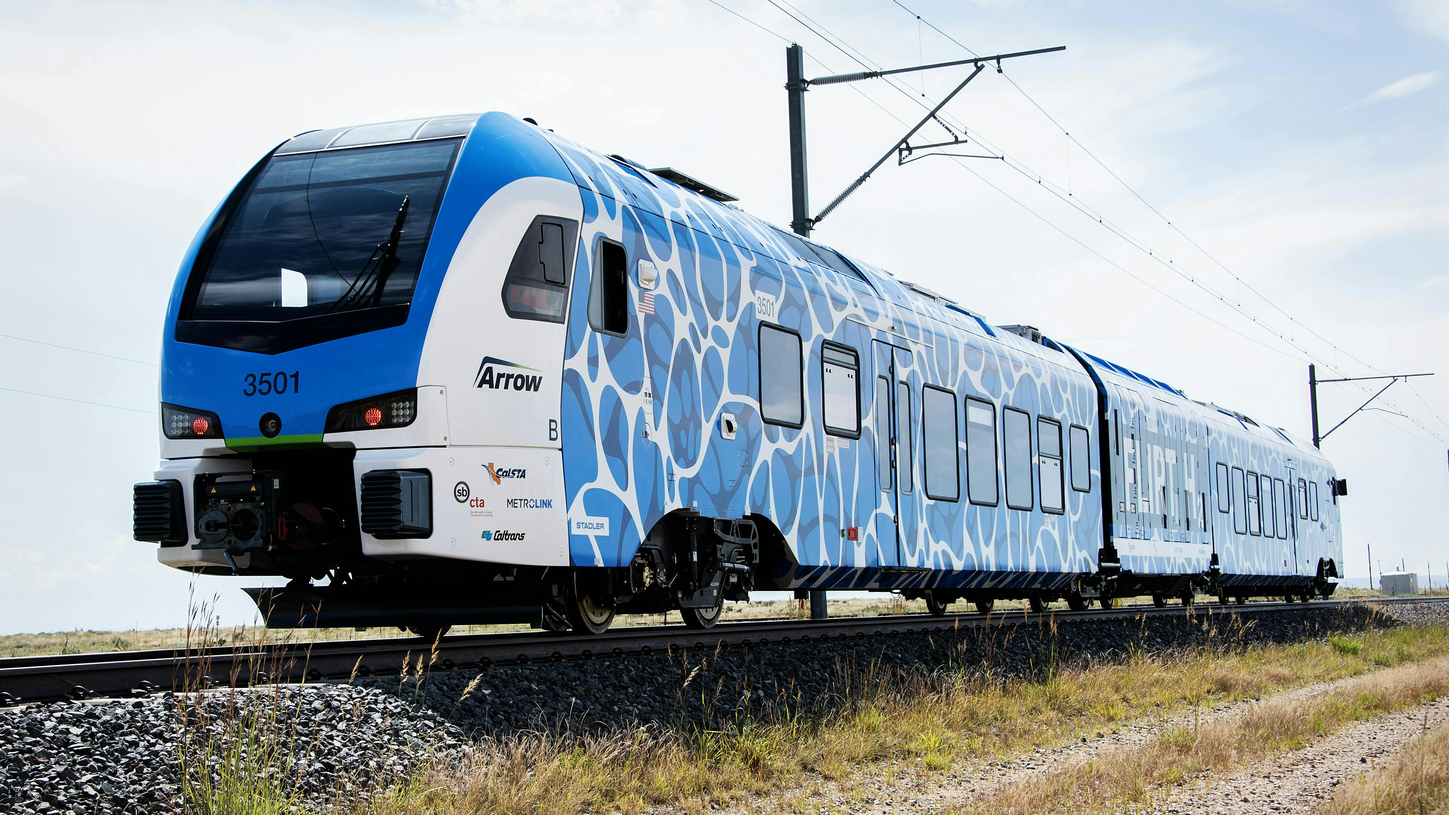 Stadler FLIRT ZEMU train in blue and white wrapping runs on test track at TTC