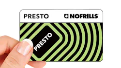 The image displays a hand holding the limited edition No Frills PRESTO card. The image displays a hand holding the limited edition No Frills PRESTO card.