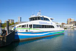 The image shows an MBTA ferry on the water. The image shows an MBTA ferry on the water.
