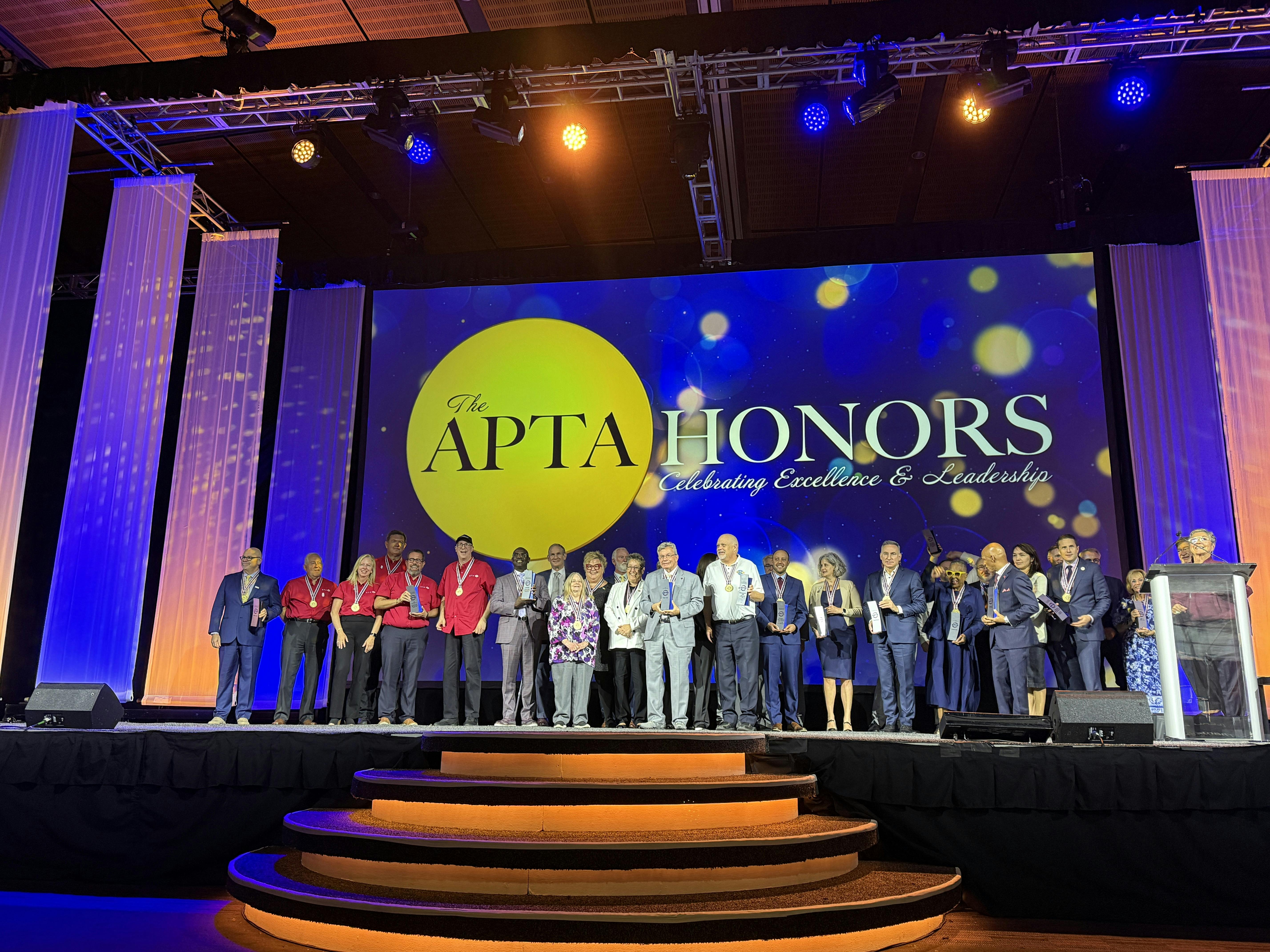 The image displays the APTA Honors award winners on the ballroom stage.
