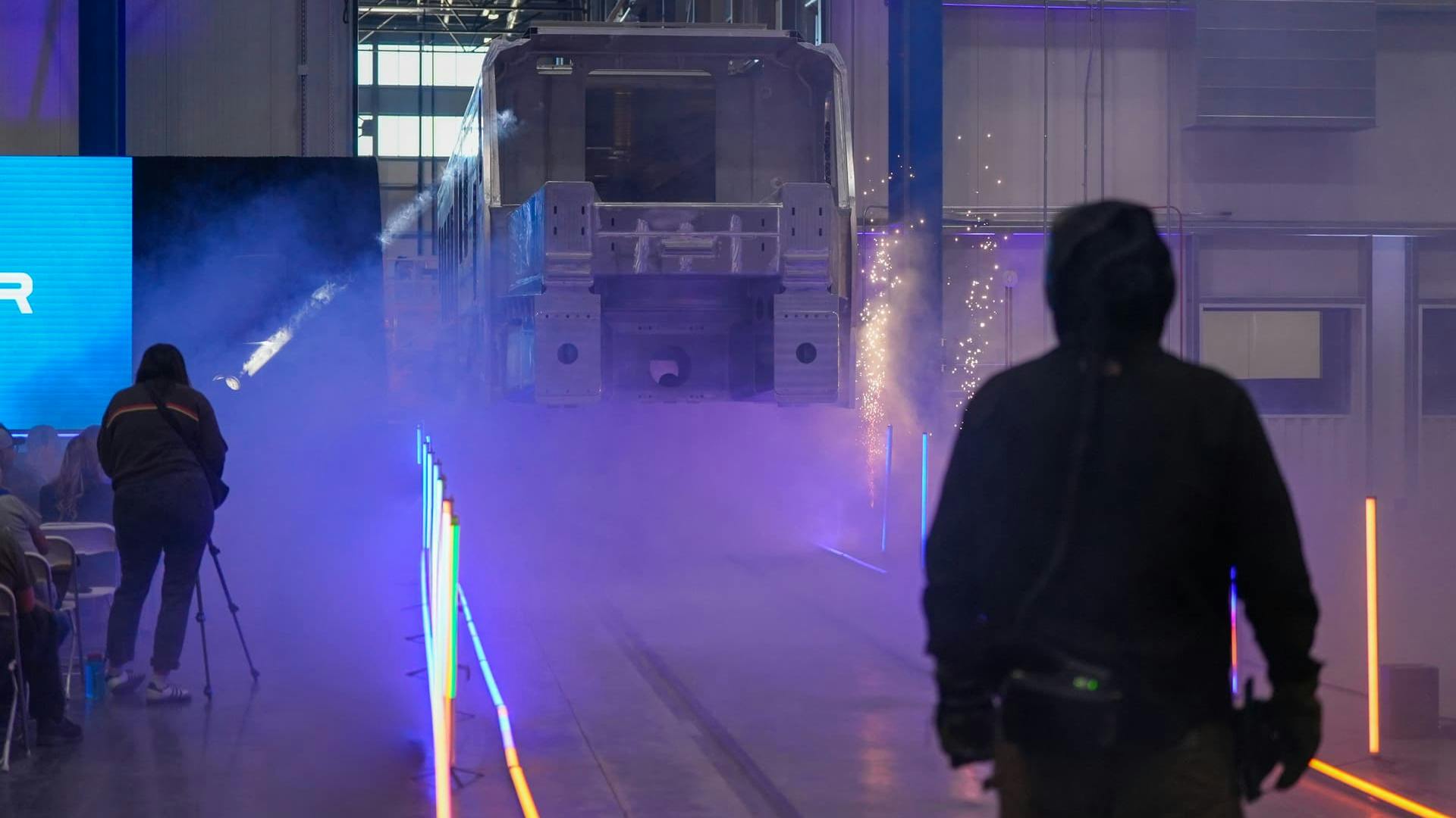 Welders work on an aluminum car body at Stadler's new facility.