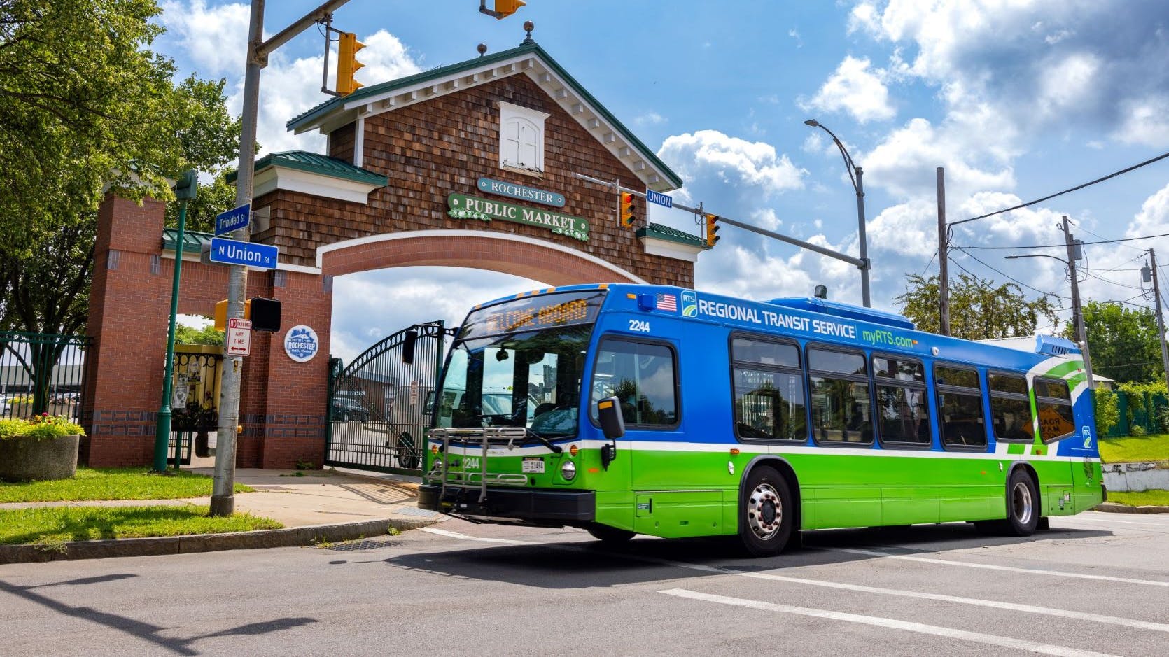 A Rochester RTS bus drives down a street.