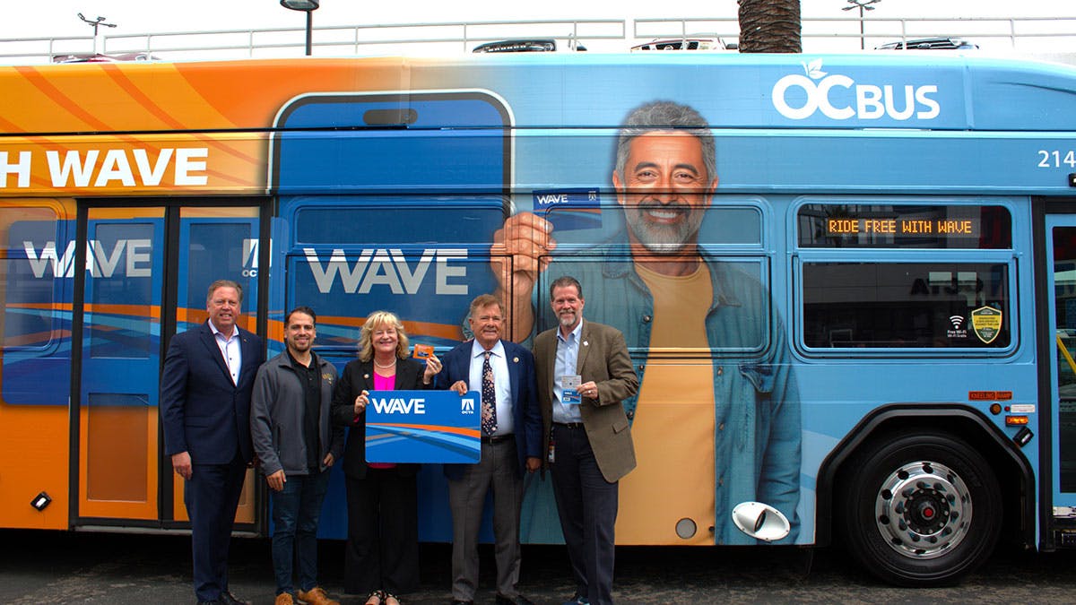 Orange County Transportation Authority Board Members and staff get a first look at the Wave card and a bus wrapped with the Wave logo to promote the new program after a Board of Directors meeting on Monday, Oct. 13.