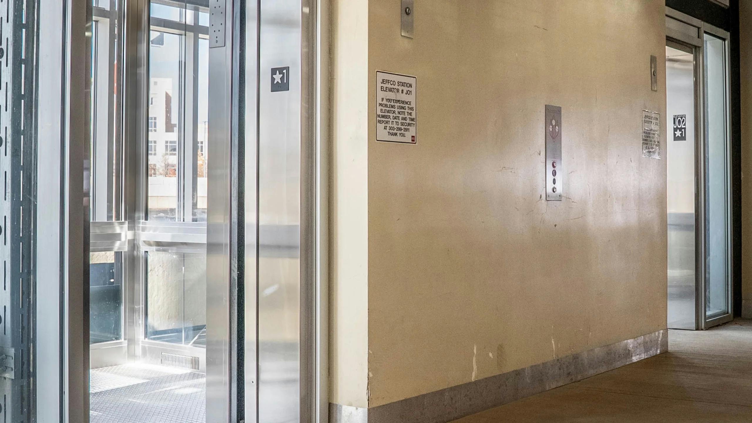 A bank of elevators host open doors.