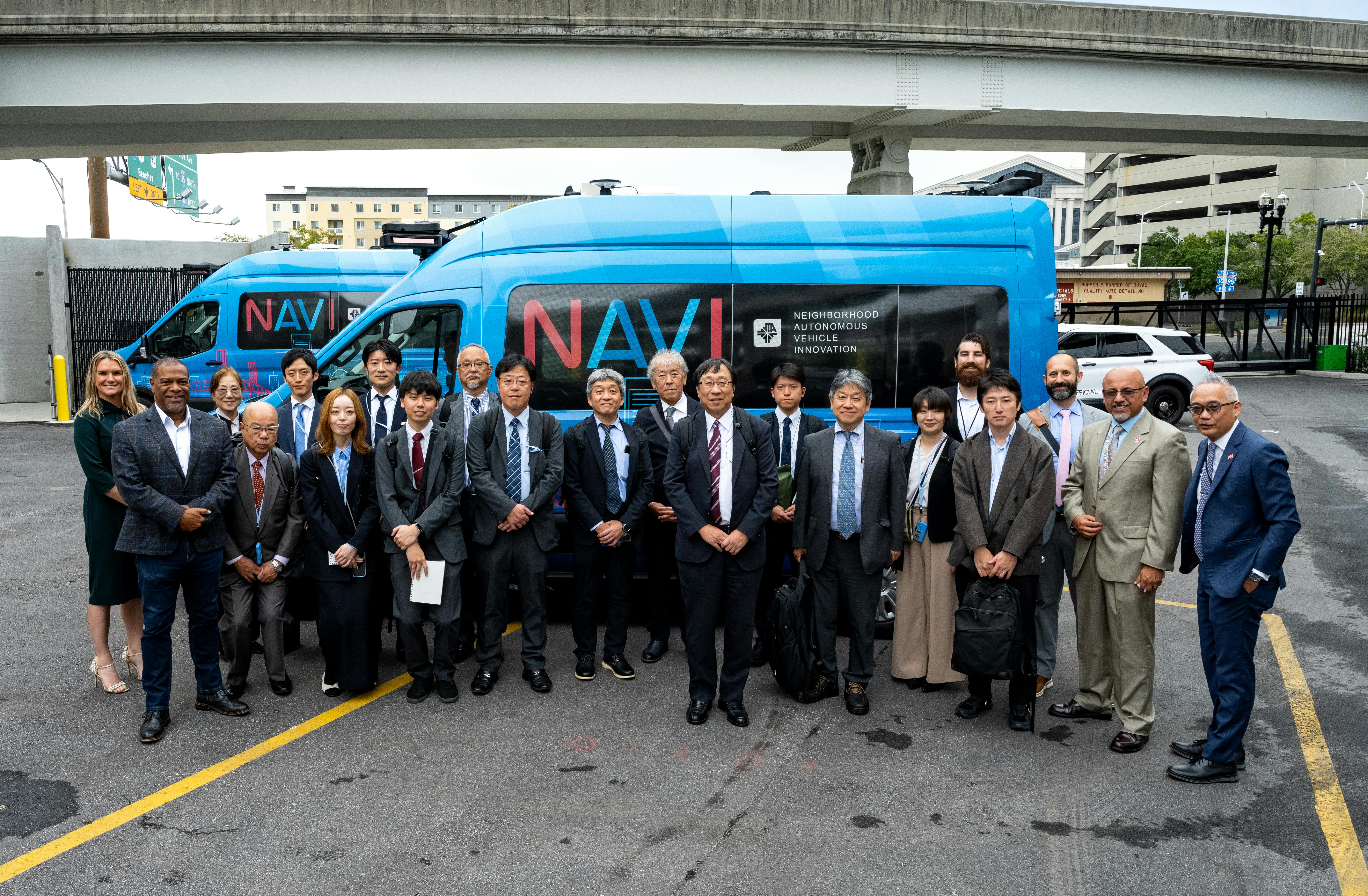 The image displays a group shot of the delegation with local leaders.